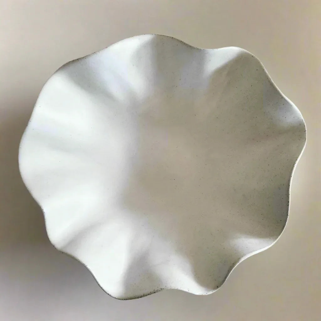 Large white ceramic wave bowl styled in a coastal-inspired interior
