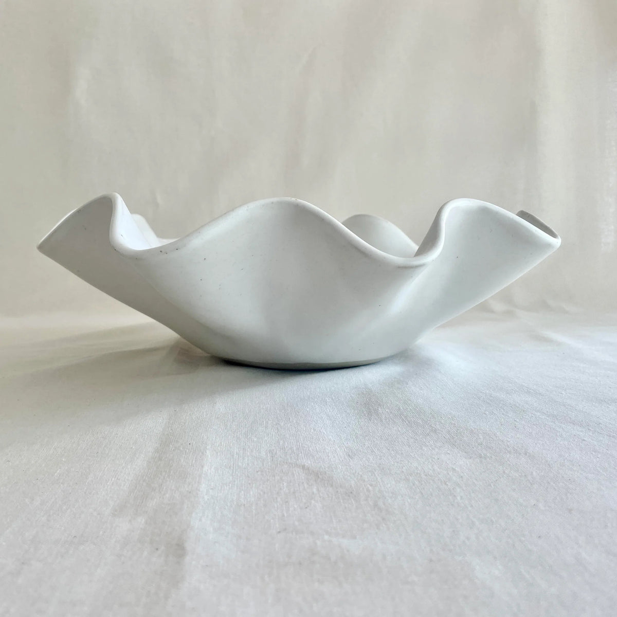 Large white wave bowl shown on a kitchen bench