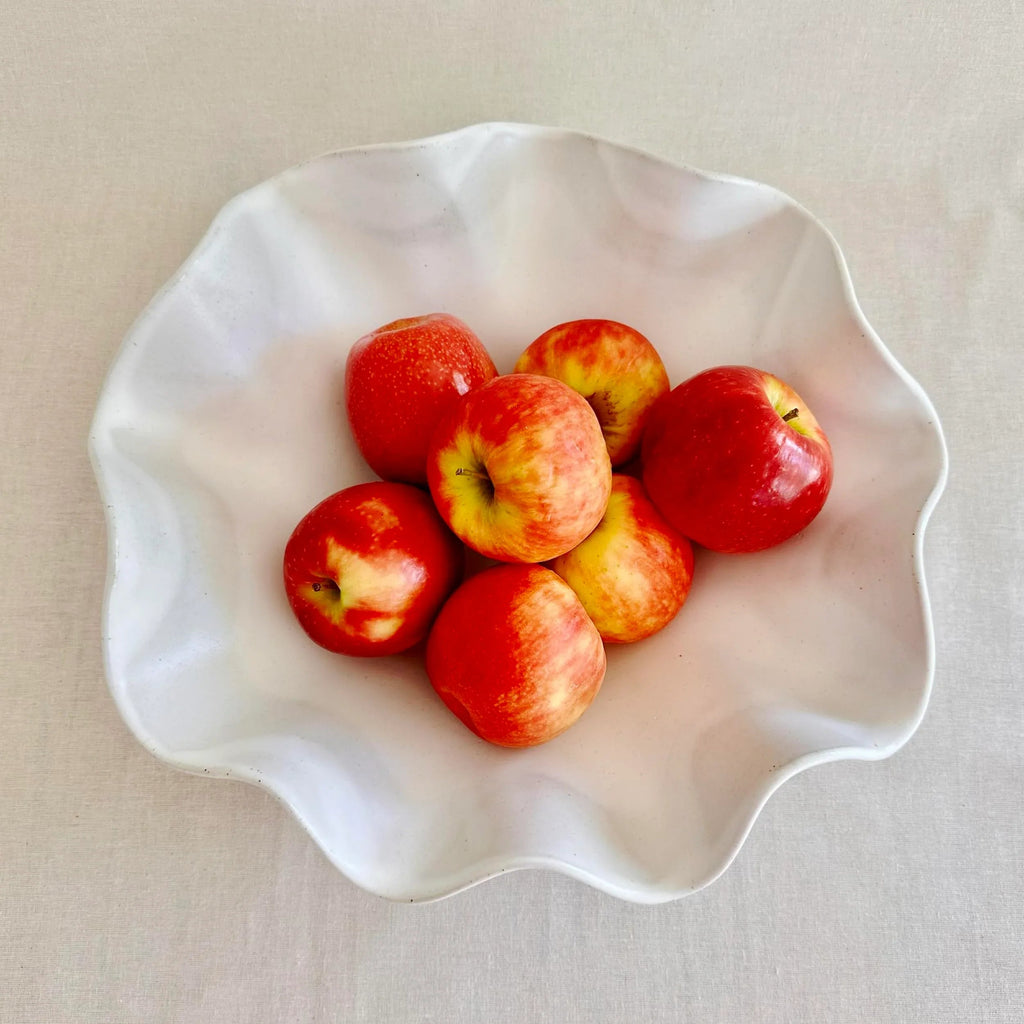 Large white wave bowl shown holding fruit as a centrepiece