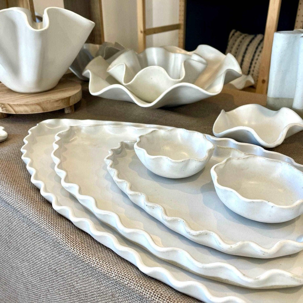 White wave dip bowl styled alongside ceramic serving platters for entertaining