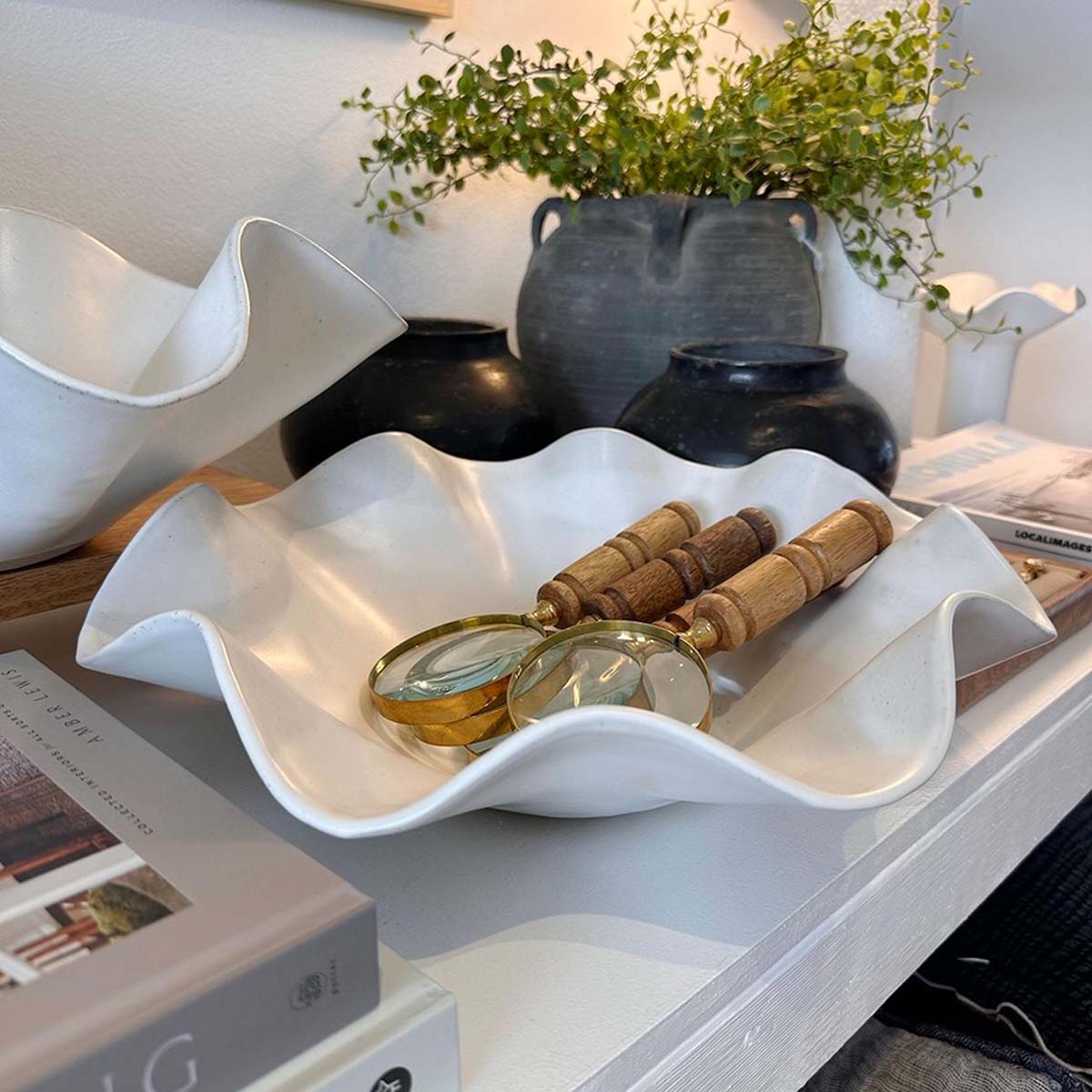 Angled view of the large white wave bowl showing satin glaze finish