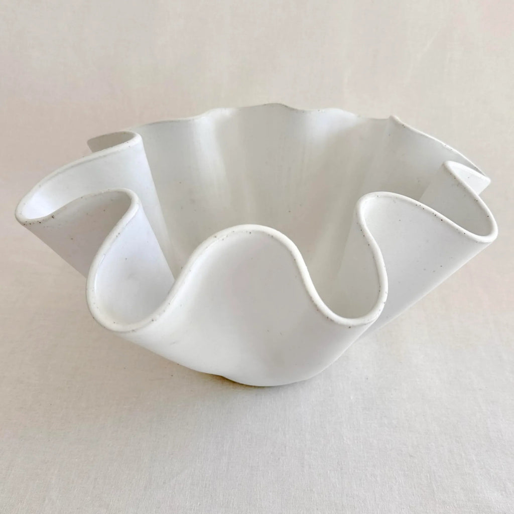 Side view of the large white high sided wave bowl in natural light
